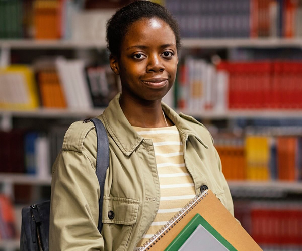 Students studying with books in bright classroom environment